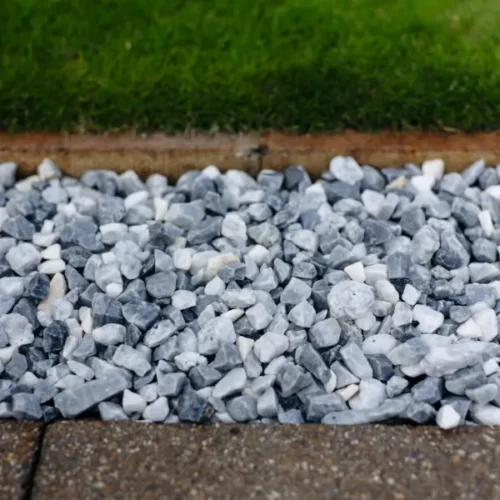 Alpine Blue gravel chippings used in a border between paving and fresh garden turf